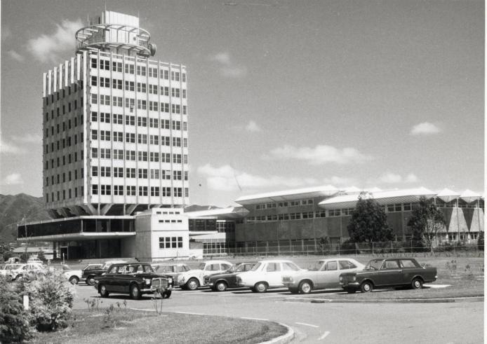 A black and white landscape image showing the Avalon TV Centre administration block tower and studios with 1970s cars parked in the foreground.